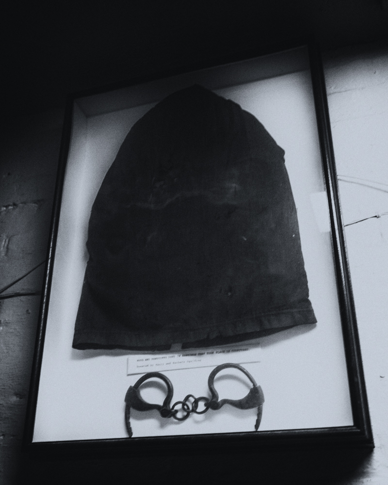 Hood placed over the head prior to hanging, and cuffs for the condemned on display at the Jailer's Inn.